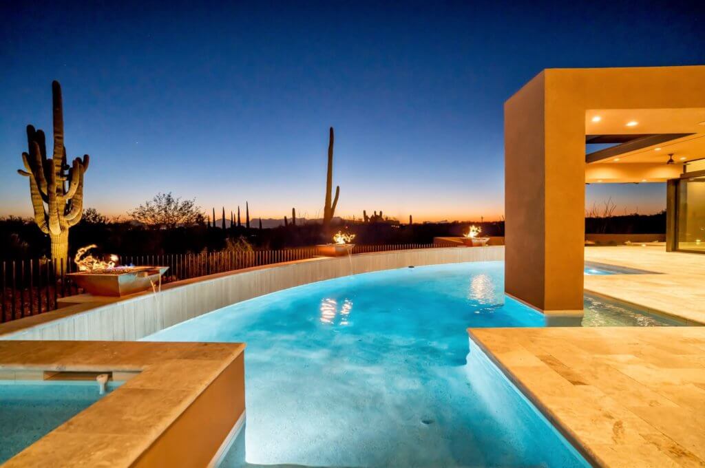 A large modern home and pool with a view of the desert outside of Tucson