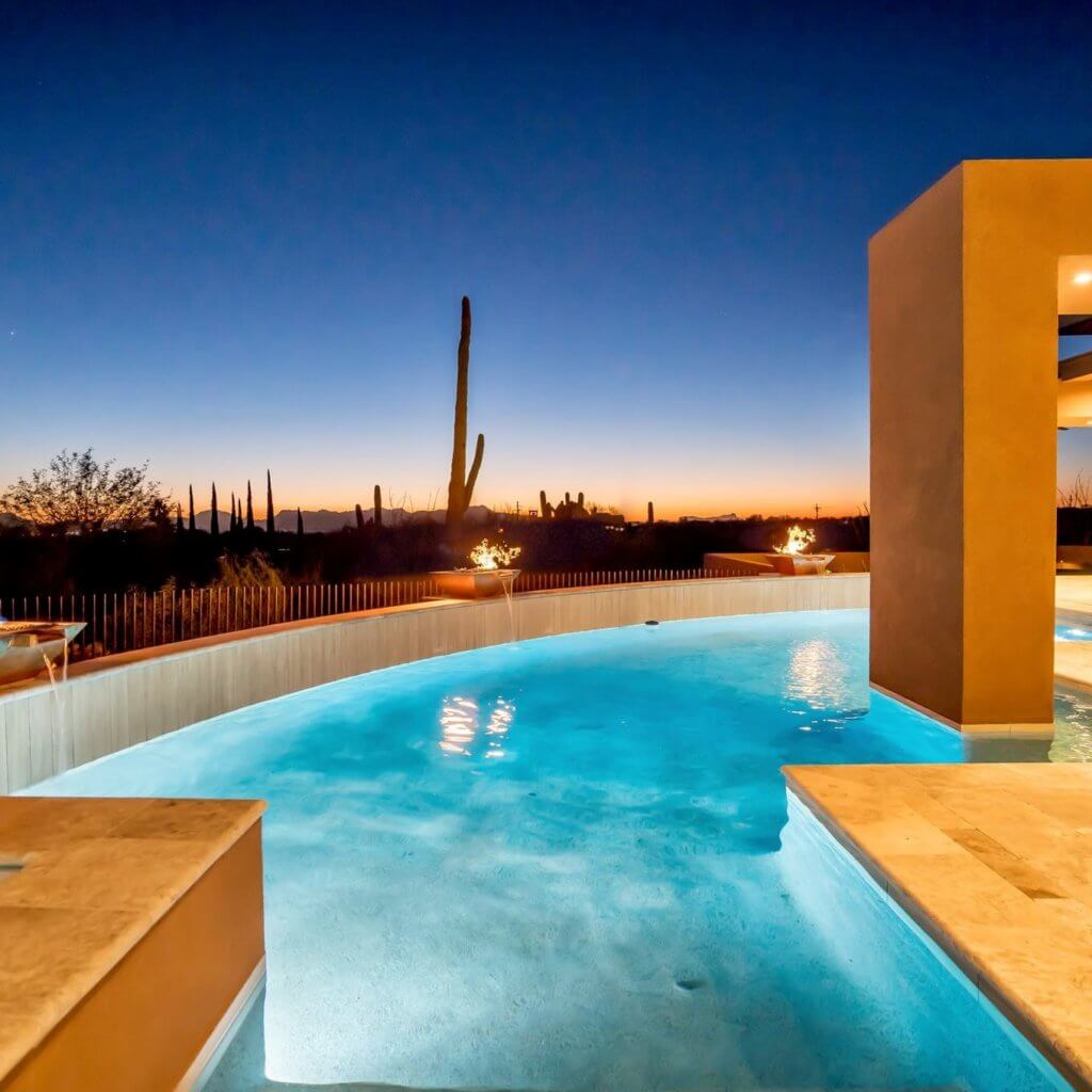 A large modern home and pool with a view of the desert outside of Tucson