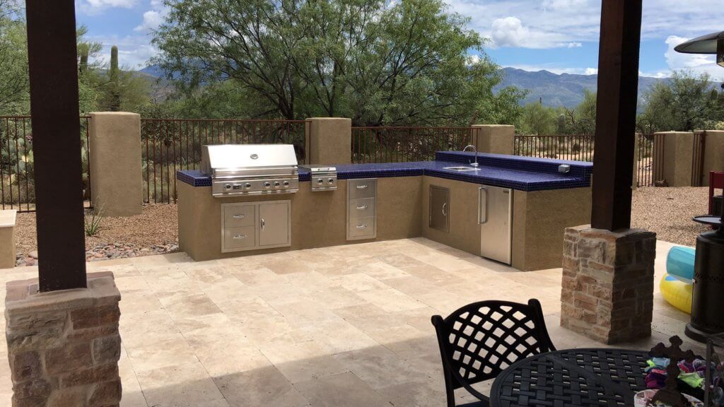 An outdoor kitchen with blue tile counter top
