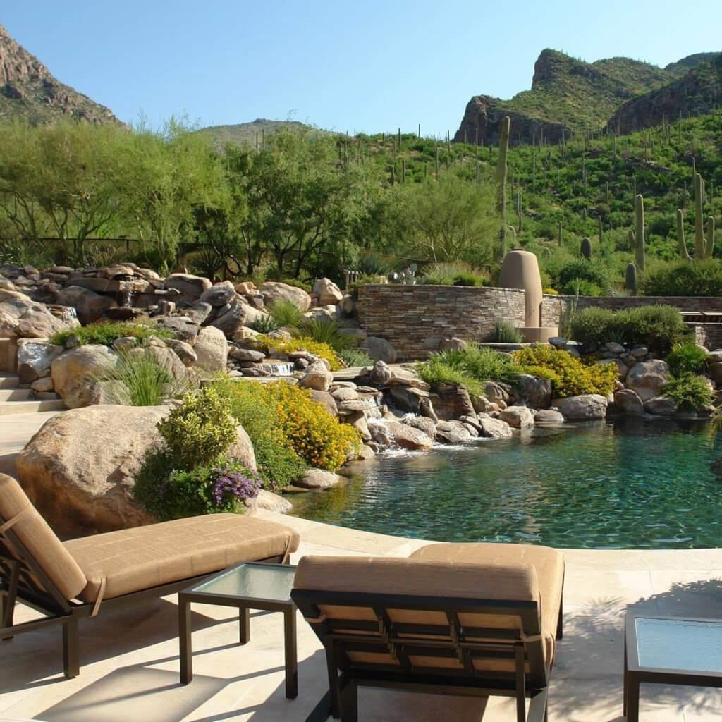 Custom landscape design with a waterfall and pool with a view of the mountains