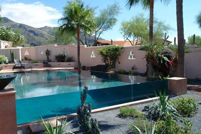 A large custom pool with a waterfall edge