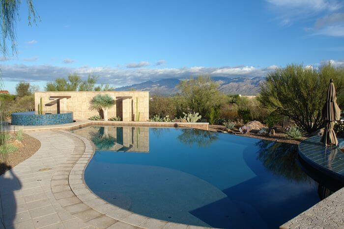 A large pool and hot tub with a view of the Arizona mountains