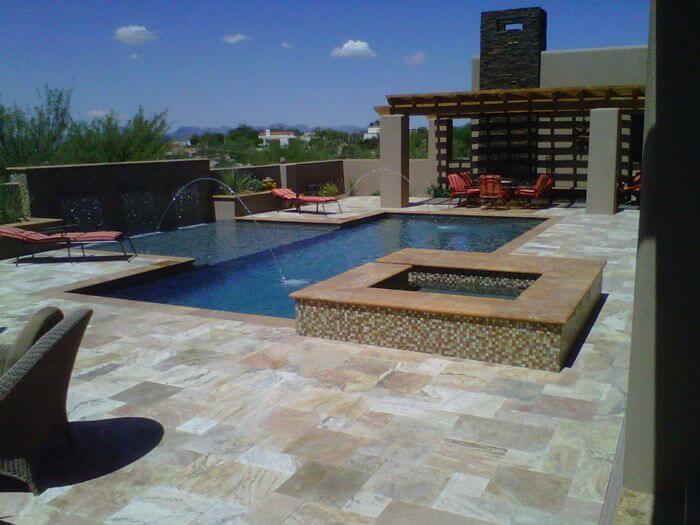 Large patio in Tucson with custom pool, hot tub, and pergola