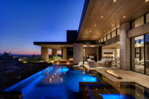 A beautiful custom patio project completed by Cimarron Circle Construction with a pool and hot tub