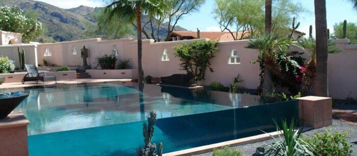 A large custom pool with a waterfall edge